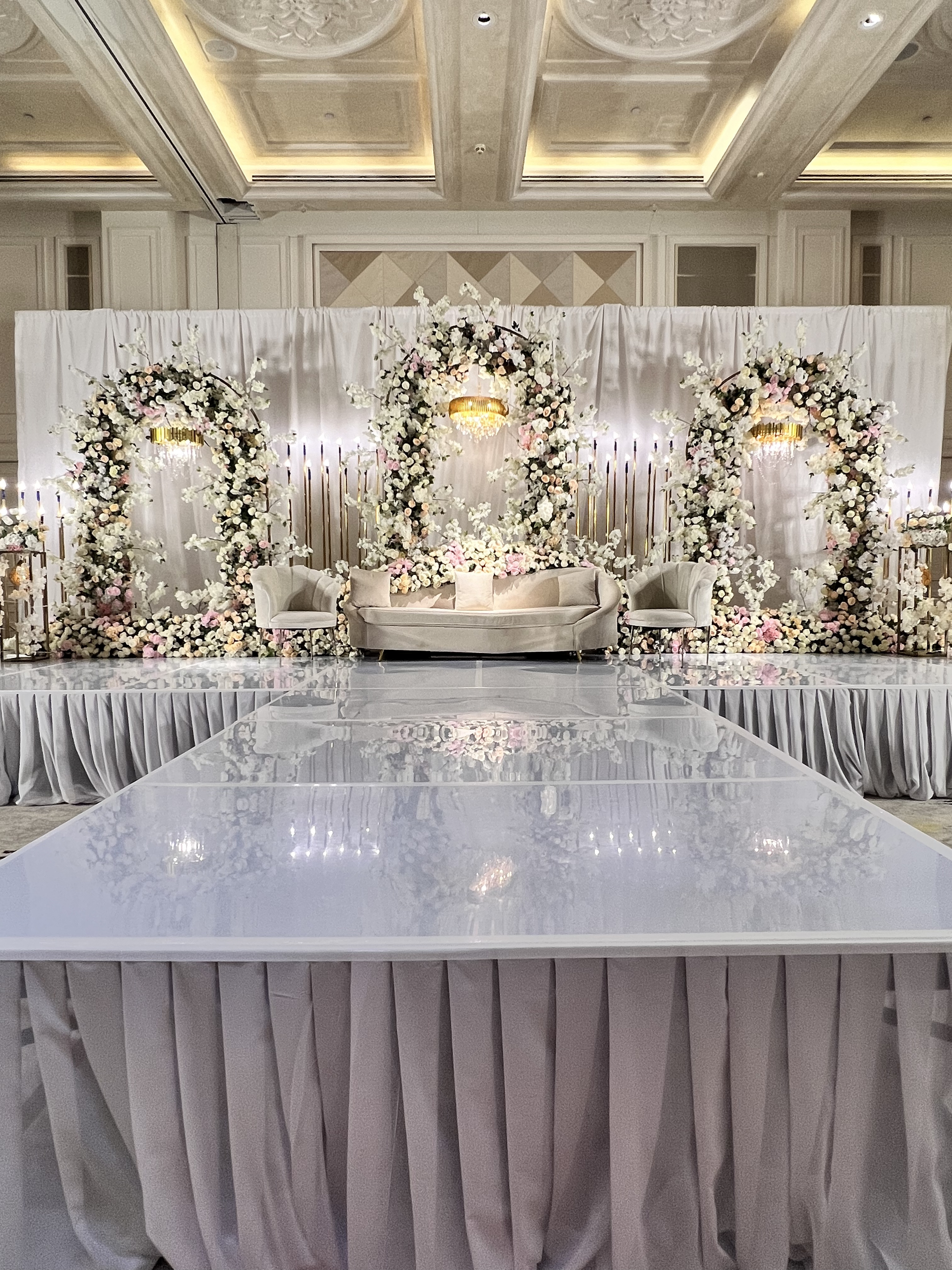 Ehtaram Events — grand wedding hall decoration with floral arch Dubai